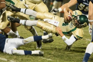 Dano Graves is brought down by the Northern Arizona Lumberjacks defense. By Owen Main